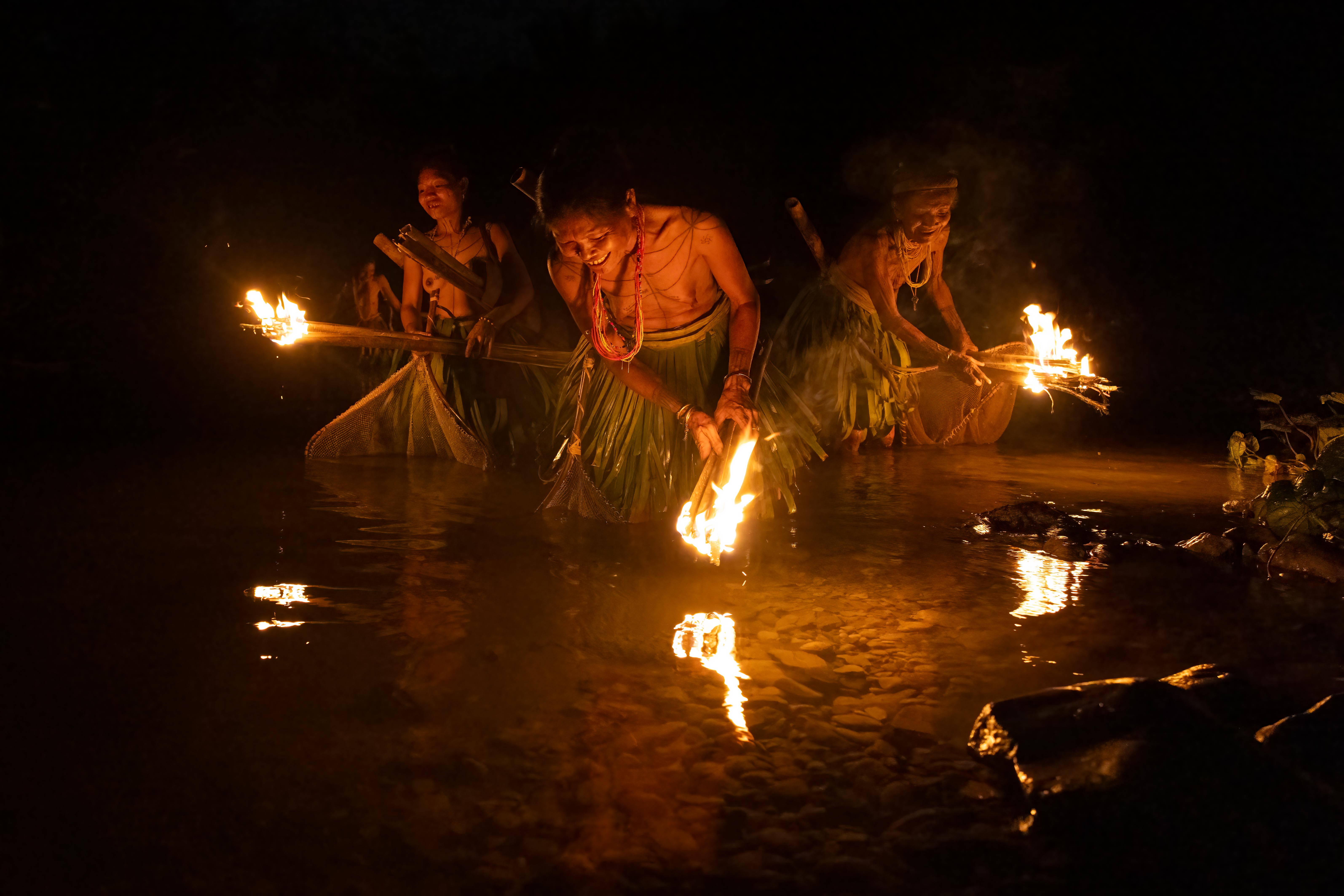 Mentawai women fishing night siberut island, west sumatra indonesia
